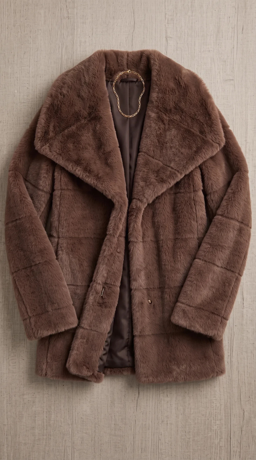 The coat laid flat on a table, shot from above