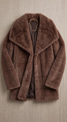 The coat laid flat on a table, shot from above